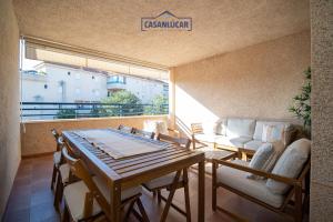 een kamer met een tafel, stoelen en een bank bij Vivienda Magallanes in Sanlúcar de Barrameda