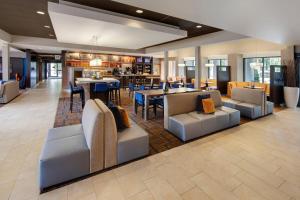 a restaurant with couches and tables and a bar at Courtyard by Marriott Atlanta Windy Hill/Ballpark in Atlanta