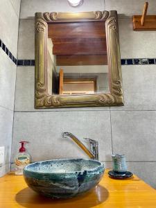 a bathroom sink with a large stone vessel sink at Alewekehue , la linda in San Carlos de Bariloche