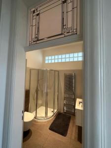 uma casa de banho com um chuveiro, um WC e um lavatório. em Villa Wingolf em Karlovy Vary