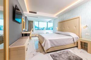 a hotel room with a bed and a tv at Grand Hotel Park in Dubrovnik