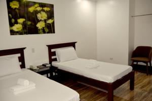 Säng eller sängar i ett rum på Isla De Oro Hotel
