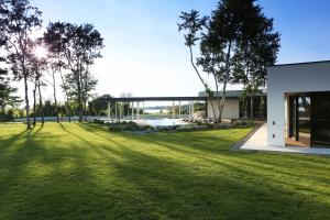 a rendering of the exterior of a building with a grass yard at Villa Calvia Crispinilla in Novigrad Istria