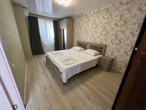 a bedroom with a bed and a wall at villa with beautiful view 4 in Tbilisi City