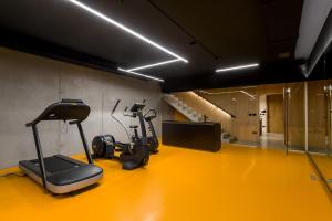 a gym with cardio equipment on a yellow floor at Villa Calvia Crispinilla in Novigrad Istria