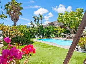 a pool in a yard with pink flowers at That Cape Town House in Dagbreek