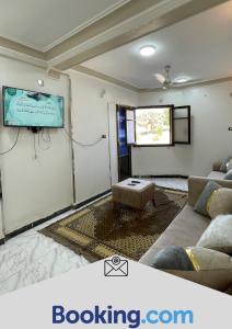 a living room with a couch and a flat screen tv at Tabia Tower City center aswan in Aswan