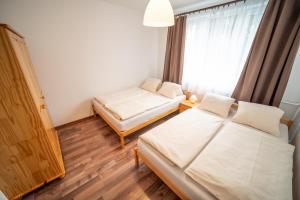 Posteľ alebo postele v izbe v ubytovaní Apartmány Olešnice
