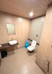 a bathroom with a sink and a toilet in it at Hotel Hill View Nalasopara in Sopāra