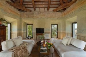 a living room with two white couches and a tv at Massimago Wine Tower in Padova