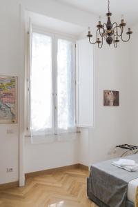 a white bedroom with a bed and a window at Home The River in Rome