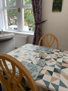 a dining room table with a checkered table cloth at The Snug on Hornby in Morecambe