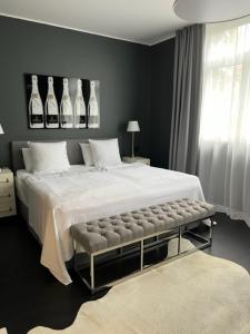 a bedroom with a large bed with bottles on the wall at InkBlue-Apartment in Heidenau