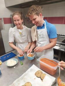 a man and a woman standing in a kitchen preparing food at Il Giardino Dorato in Maiori