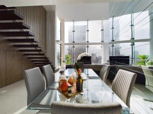 a dining room with a glass table and chairs at Amazing Skyline Views 3BR Duplex in Manchester