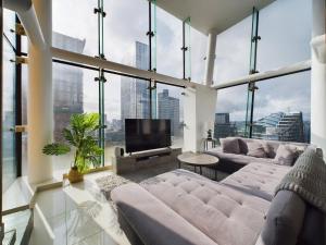 a large living room with large windows and a tv at Amazing Skyline Views 3BR Duplex in Manchester