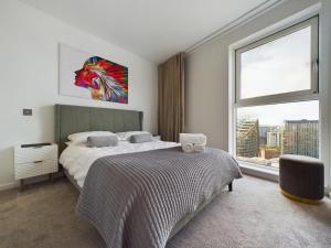 a bedroom with a bed and a large window at Amazing Skyline Views 3BR Duplex in Manchester