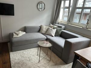 a living room with a couch and a table at Inselresidenz Strandburg - Ferienwohnung 106 in Juist