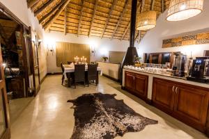 a dining room with a table and a counter with candles at Elephant Rock Private Safari Lodge in Ladysmith