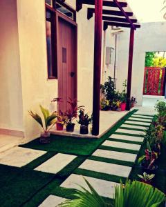 a house with a pathway with plants in front of it at Blue Haven Retreat in Thulusdhoo