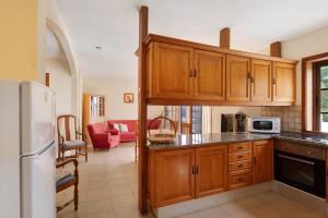 a kitchen with wooden cabinets and a refrigerator at Moijama 4 in Los Llanos de Aridane