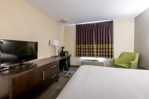 a hotel room with a bed and a flat screen tv at Super 8 by Wyndham Truro NS in Truro