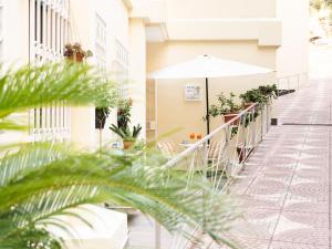 a patio with tables and an umbrella on a building at Lemon Tree in Vico Equense