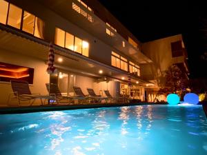 a swimming pool in front of a building at night at KAMOME SLOW HOTEL the COMPACT in Awaji +39 photos