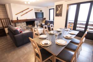 a dining room and living room with a table and chairs at Résidence la Souccarade in Font-Romeu