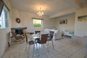 a living room with a table and chairs and a couch at House with sea breeze-Anemelia in Nafplio