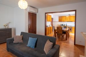 a living room with a couch and a dining room at Emily's House in Arcos de Valdevez