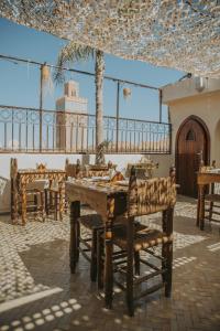 a restaurant with a wooden table and chairs at Riad Casa Kasbah in Marrakech