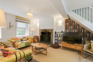 a living room with a large television and a fireplace at Lilac Cottage in Parkend