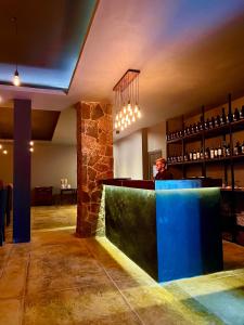 a person sitting at a bar in a restaurant at Rainforest Hotel & Cabañas in Puerto Iguazú
