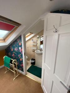 a bathroom with a door and a sink and a toilet at ByTheSea in Malahide