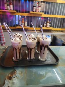 four milkshakes on a tray on a table at Country Green Hotel & Banquet in Bareilly