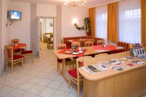 a dining room with tables and chairs and a unintention at Pension Elisabeth in Sankt Pölten