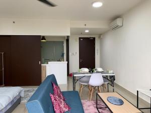 a living room with a couch and a table at Cozy Skyview DillaSuite-Trefoil (Wifi,Pool,Netflix) in Shah Alam