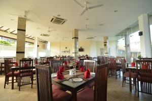 a restaurant with tables and chairs with red napkins on them at Laya Beach in Wadduwa