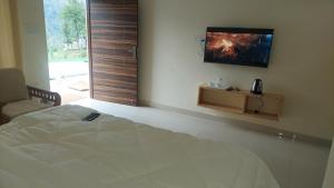Postel nebo postele na pokoji v ubytování Hotel Anandam phata