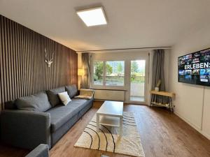 a living room with a couch and a table at Alpine Retreat: 4-Person Apartment near Zermatt in Täsch