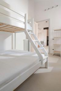 a white bunk bed in a white room at Charming loft in Venetian Villa in Noale