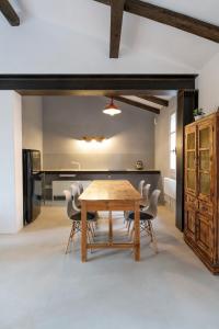 a dining room with a wooden table and chairs at Charming loft in Venetian Villa in Noale
