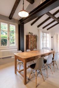 a dining room with a wooden table and chairs at Charming loft in Venetian Villa in Noale