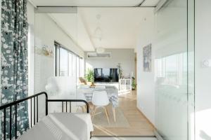 a living room with a table and a dining room at Fabulous Morden Apartment in Helsinki in Helsinki