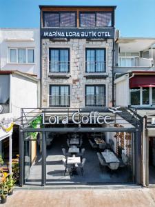 a building with a sign that reads loretta coffee at Marina Lora Butik Otel in Seferihisar