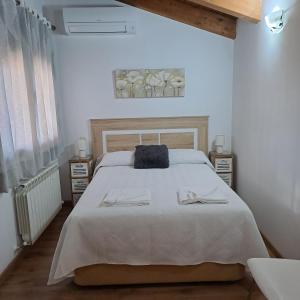 a bedroom with a large bed with two towels on it at Tranquilo apartamento vistas al Mondalindo 
