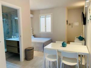 a bedroom with a bed and a table and chairs at 50 passi dal mare in Lampedusa +6 photos