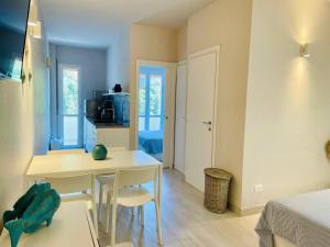 a room with a table and two chairs and a bedroom at 50 passi dal mare in Lampedusa