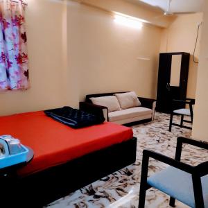 a living room with a bed and a couch at Hotel Shree Ram SIA Residency in Gaya